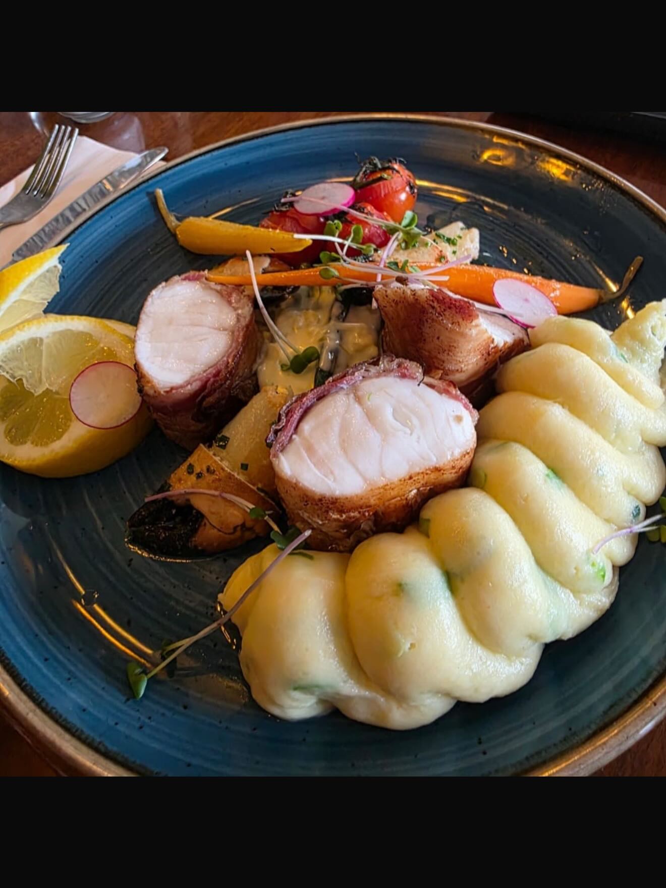 A fish special with mashed potato and vegetables